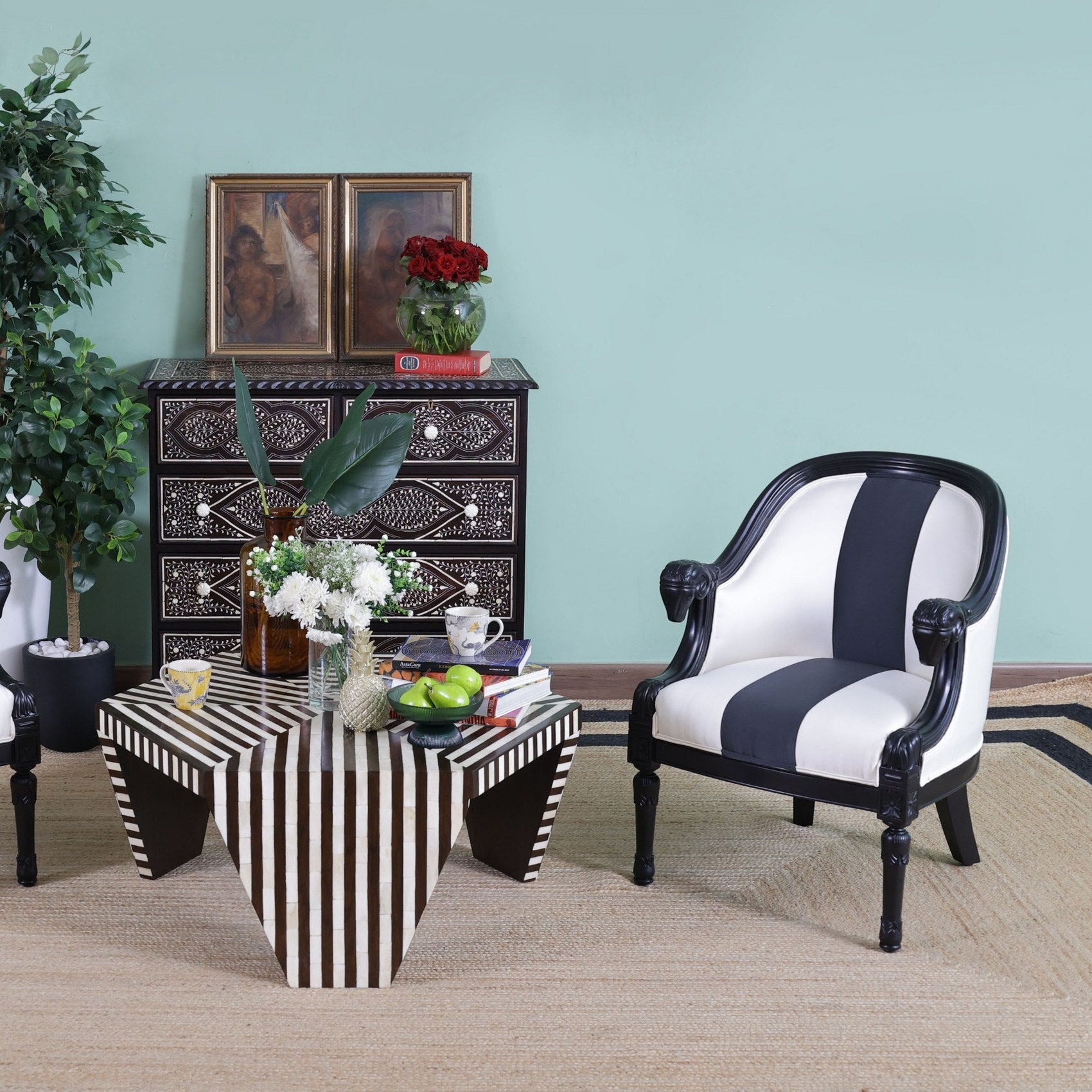 Furniture set with striped chairs and a coffee table in a room with a light blue wall.