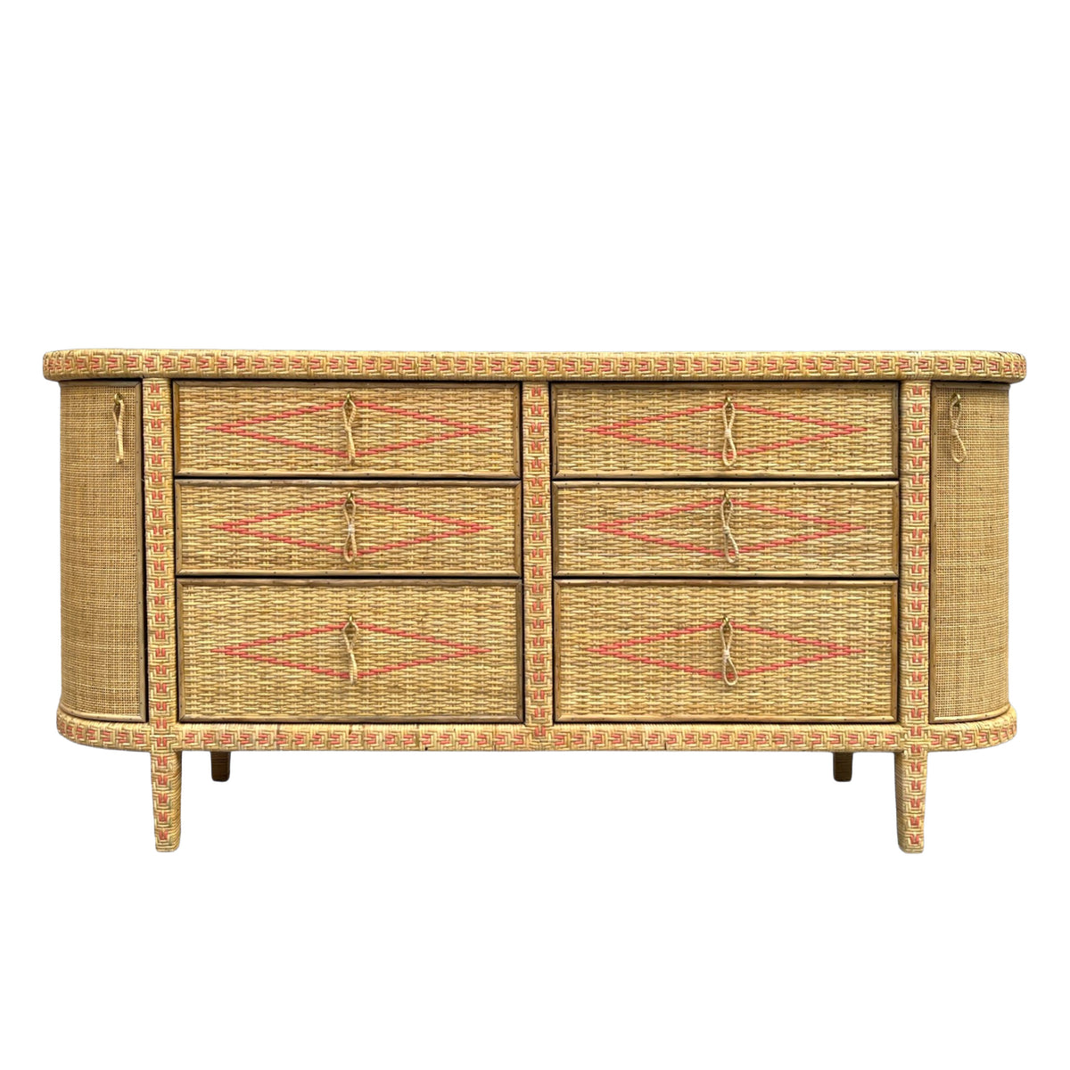 A mid-century modern wicker and rattan sideboard with six drawers, featuring a natural tan woven body with red diamond patterns on the drawer fronts and a textured beige top.